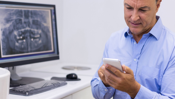 A dentist using the OrthoPhoto app
